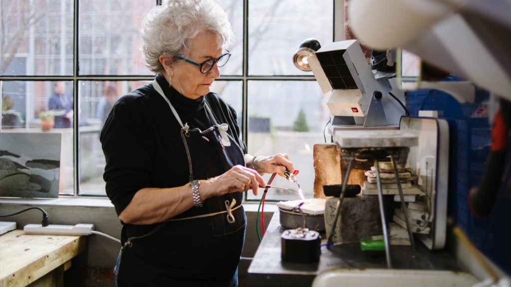 Elderly lady working in a jewellery workshop