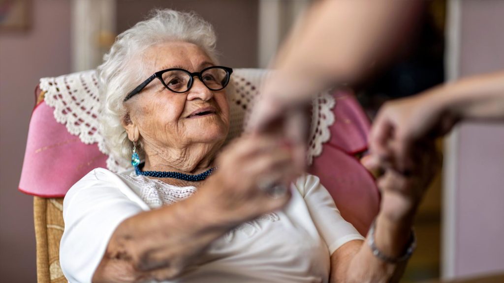 Helping a lady in care home get our of her chair